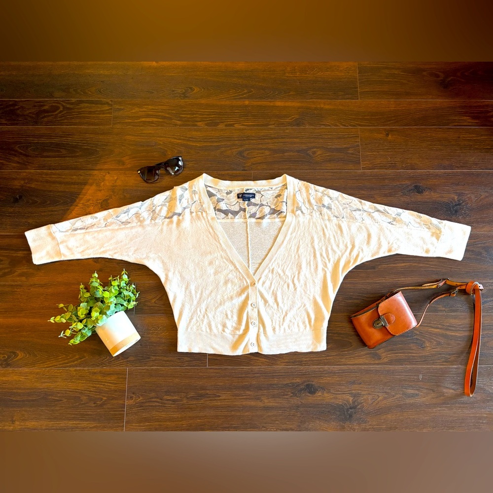 American Eagle Cropped Cream Cardigan with lace detail.